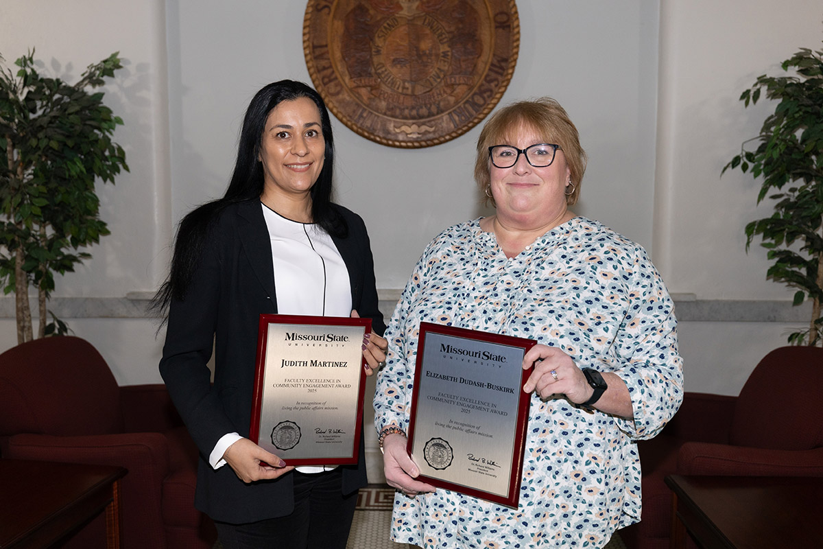 two faculty with plaques