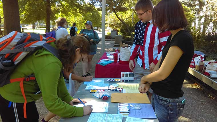 Students supervising a voter registration table.